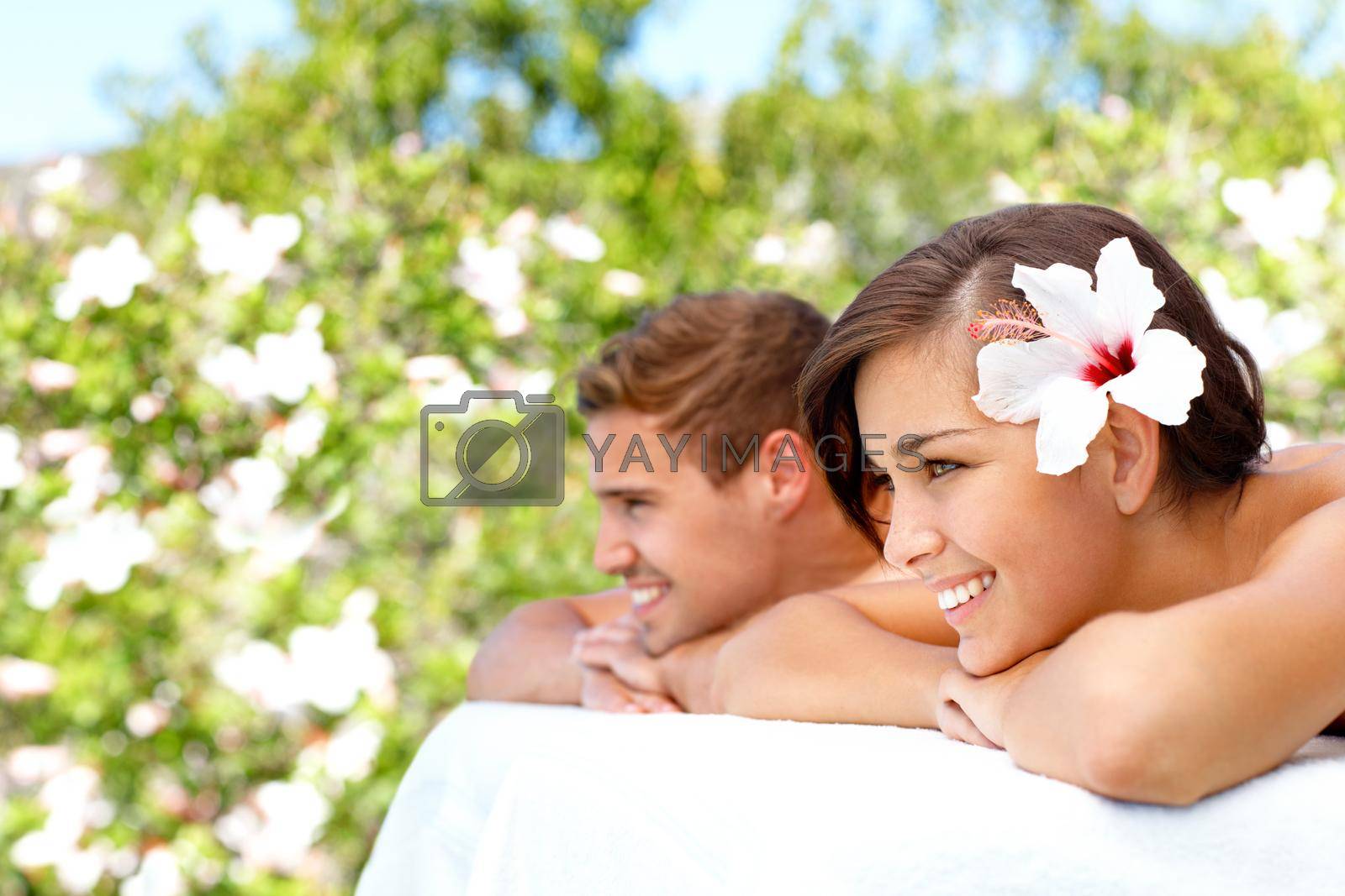 Taking a tropical spa day. Gorgeous young couple looking away during a spa day