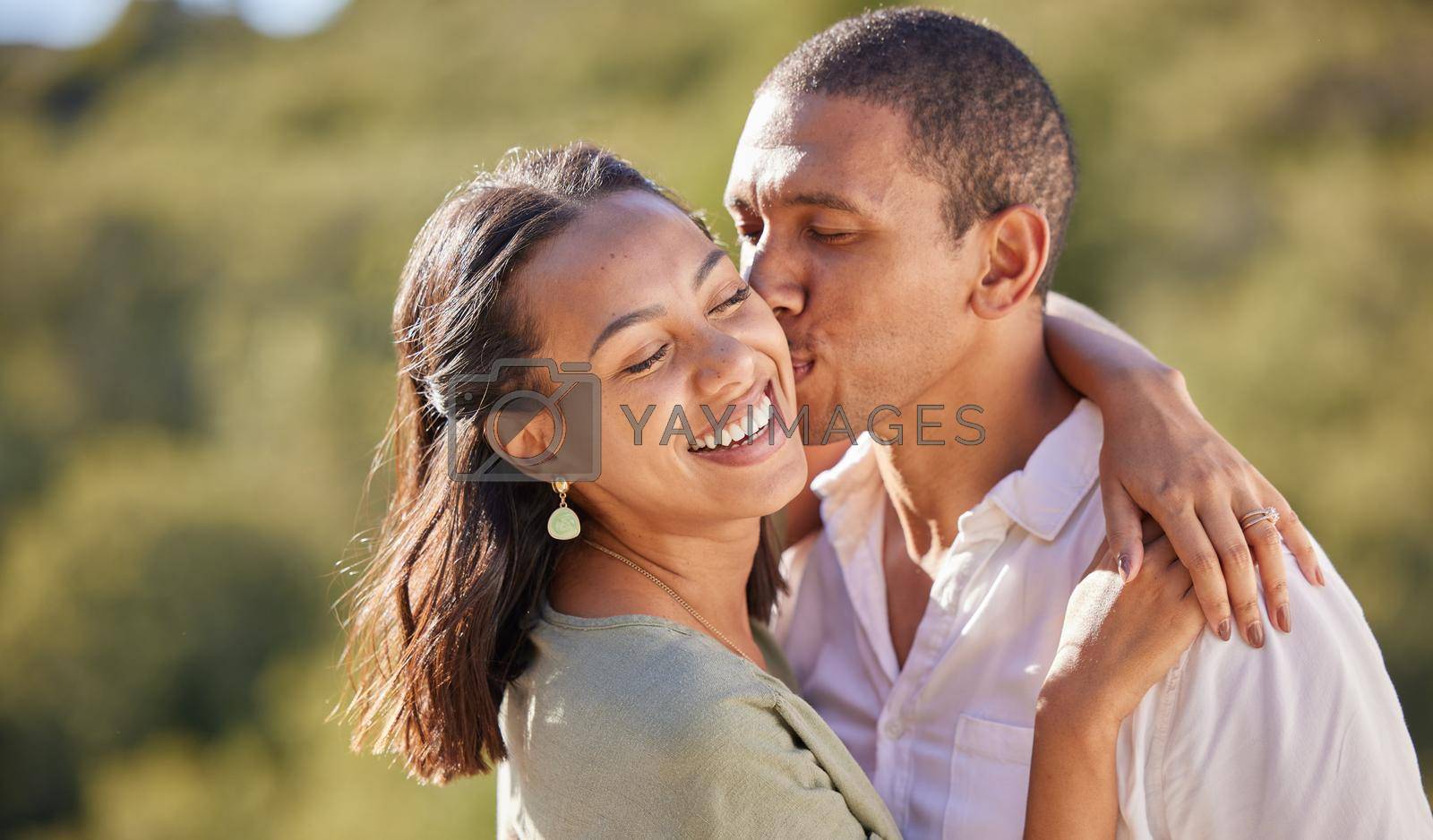 Happy black woman and man couple kiss, love and dating in relationship summer nature romance date. Hug, embrace and romantic black couple smile, kissing and happiness on vacation or holiday together.