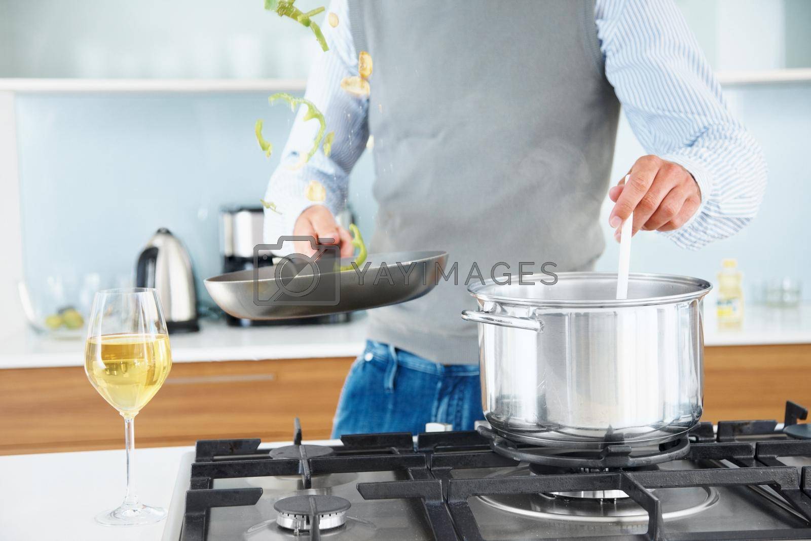 Royalty free image of Mature man preparing food in kitchen - Indoor. Cropped image of a mature man preparing food in kitchen. by YuriArcurs