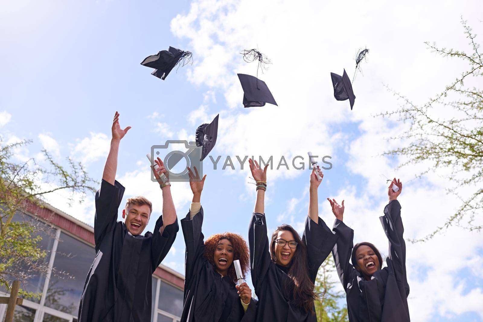 Royalty free image of Reason to celebrate. Low angle shot of student throwing their graduation hats into the air. by YuriArcurs
