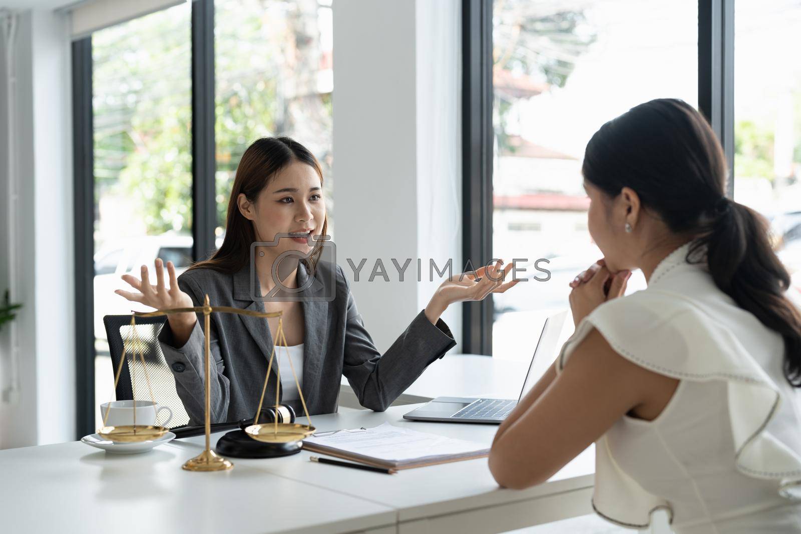 Royalty free image of The young lawyer talks to negotiate with the male client to consult the law at the law firm office. by nateemee