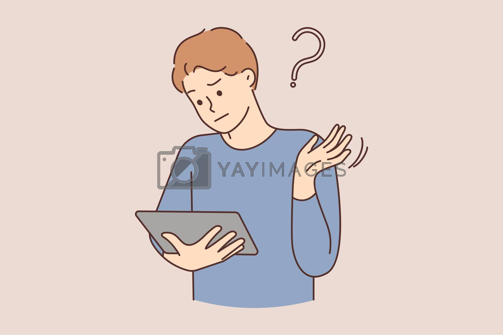 Royalty free image of Confused man shocked by problem on tablet by Vasilyeu