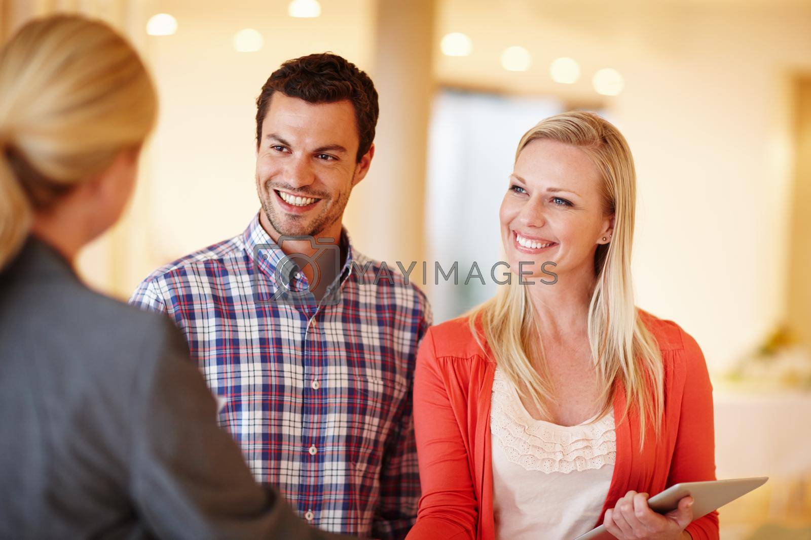 Royalty free image of Making responsible decisions about their future. A happy couple shaking hands with their financial consultant in their home. by YuriArcurs