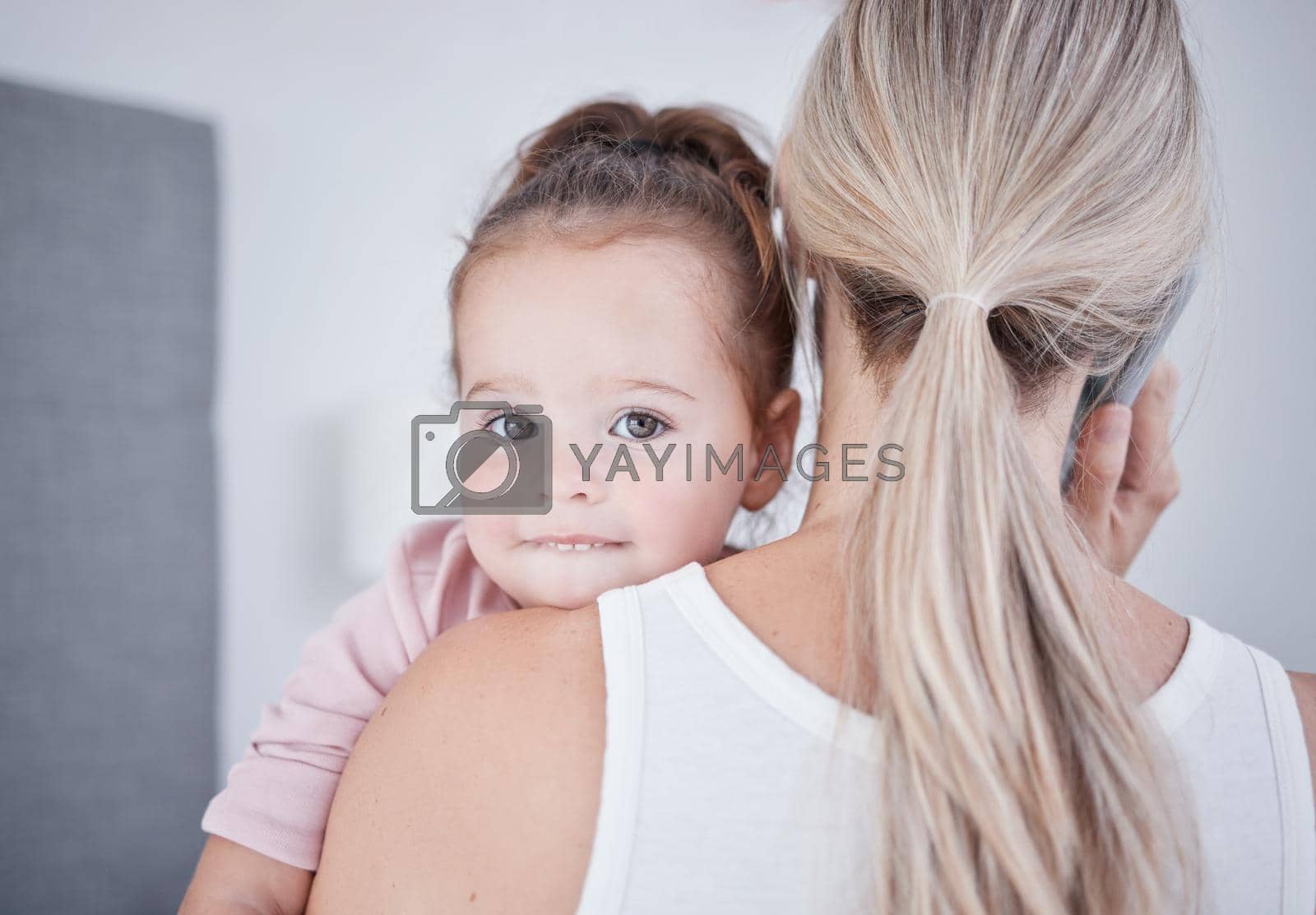 Baby, communication and mom talking in phone call conversation while multitasking on business call. Work from home single mother holding a little girl, child or kid while speaking on a mobile.
