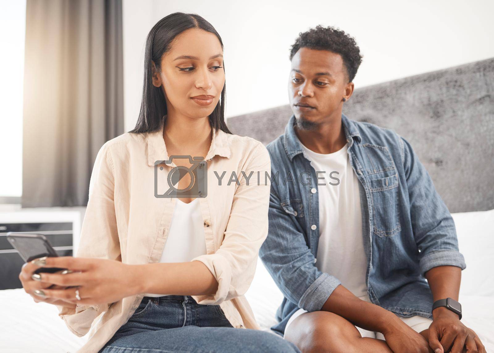 Royalty free image of Social media, secret and liar woman with phone and man reading message, text or online post. Affair, cheating and jealous couple with no trust or faith in toxic marriage relationship in the bedroom by YuriArcurs