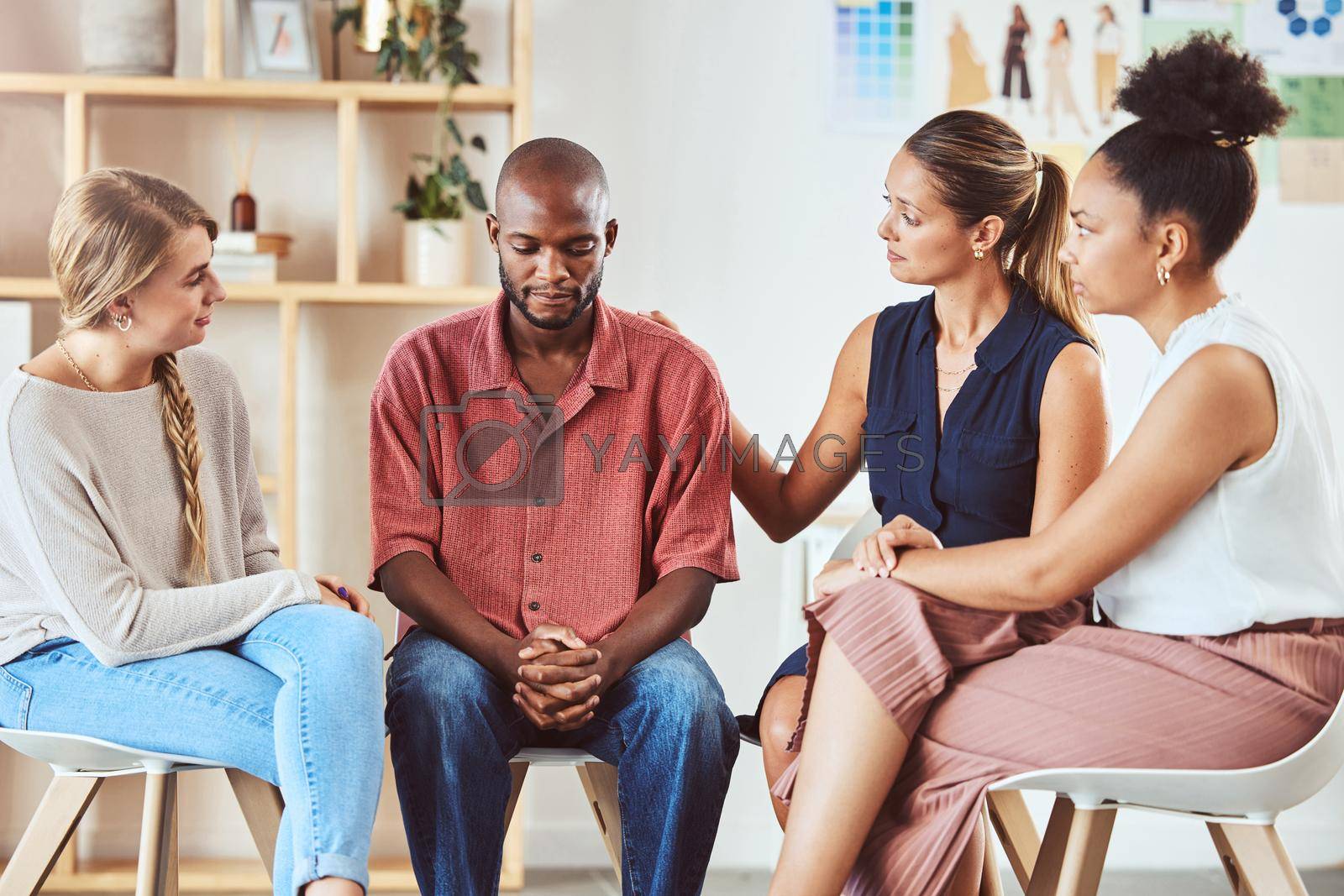 Royalty free image of Group therapy, support or mental health community in comfort of sad black man with anxiety, depression or stress. Diversity friends, women or people in counseling in psychology trust meeting for help by YuriArcurs