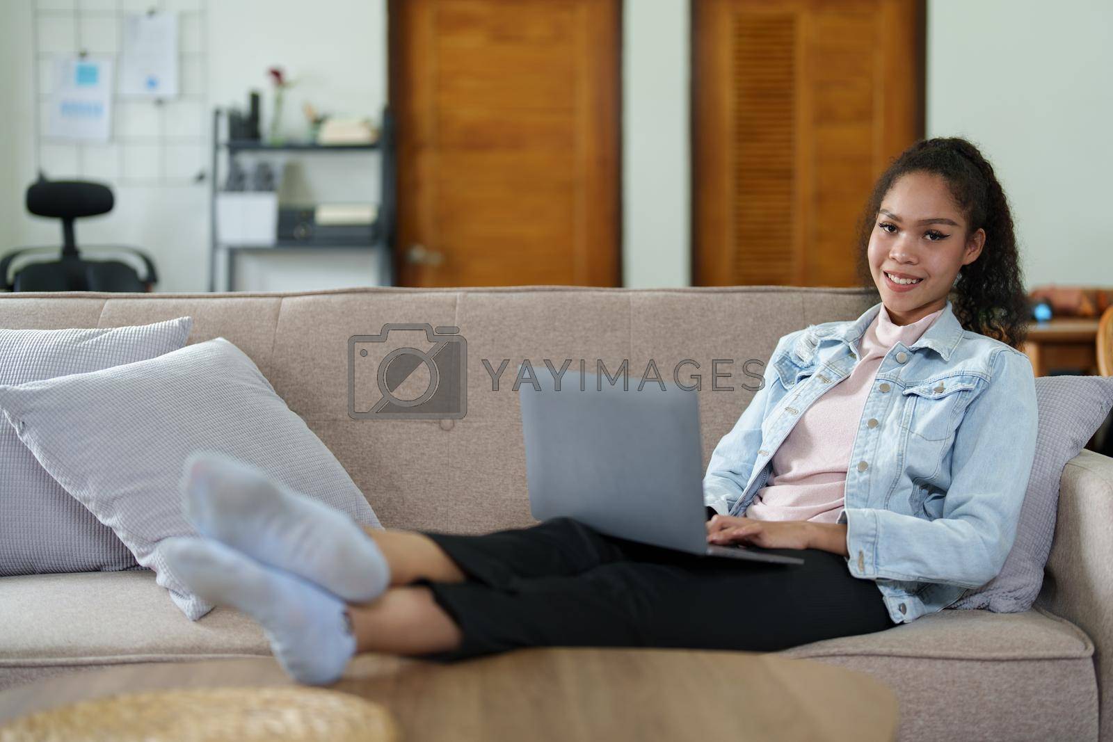 Royalty free image of Portrait of a black person using a computer at home by Manastrong