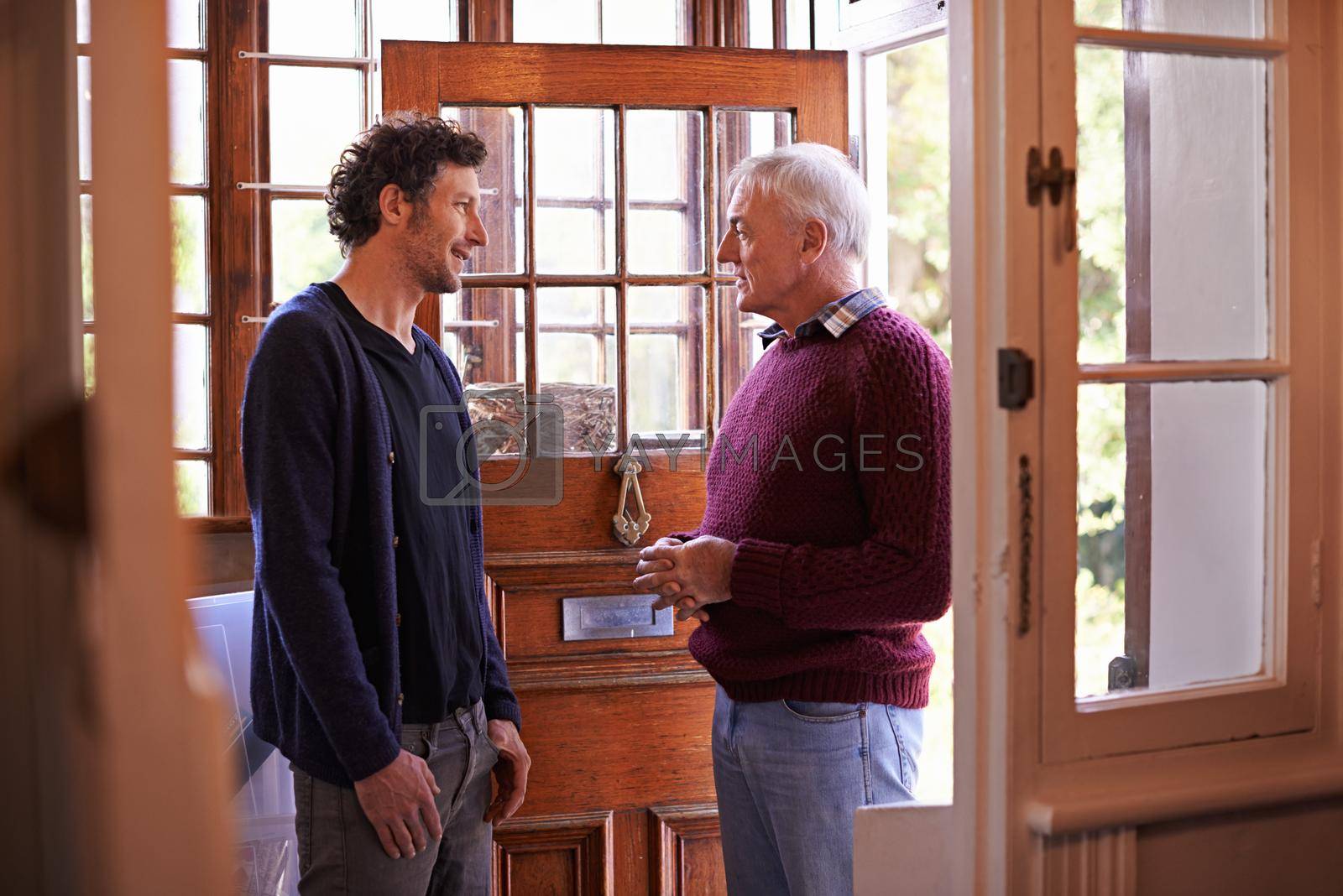 Some fatherly advise. A shot of a father and his adult son having a conversation at home