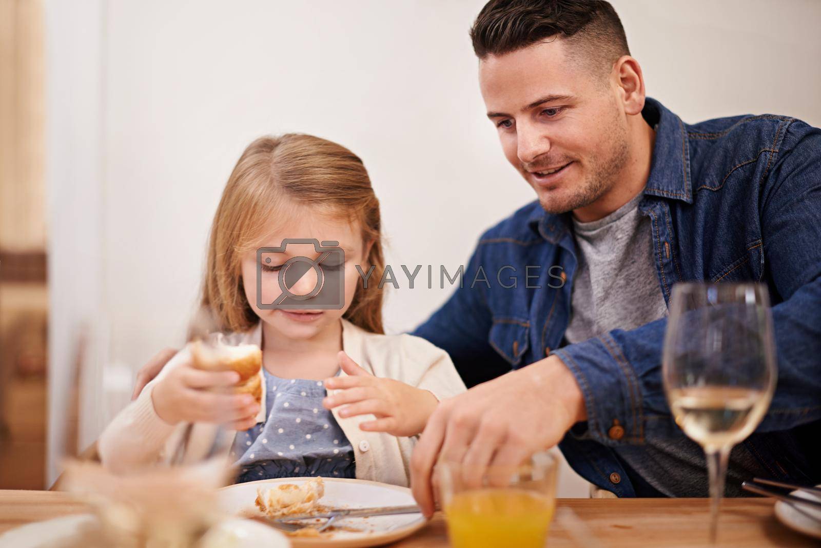 You finished, honey. a young father and his daughter sitting down to family dinner