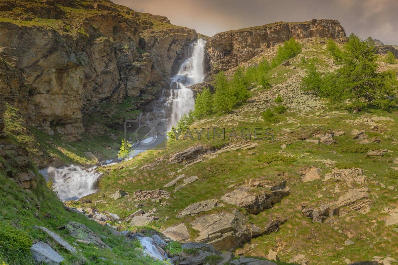 Royalty free image of Ethereal waterfall and alpine meadows at springtime, Gran Paradiso Alps, Italy by positivetravelart