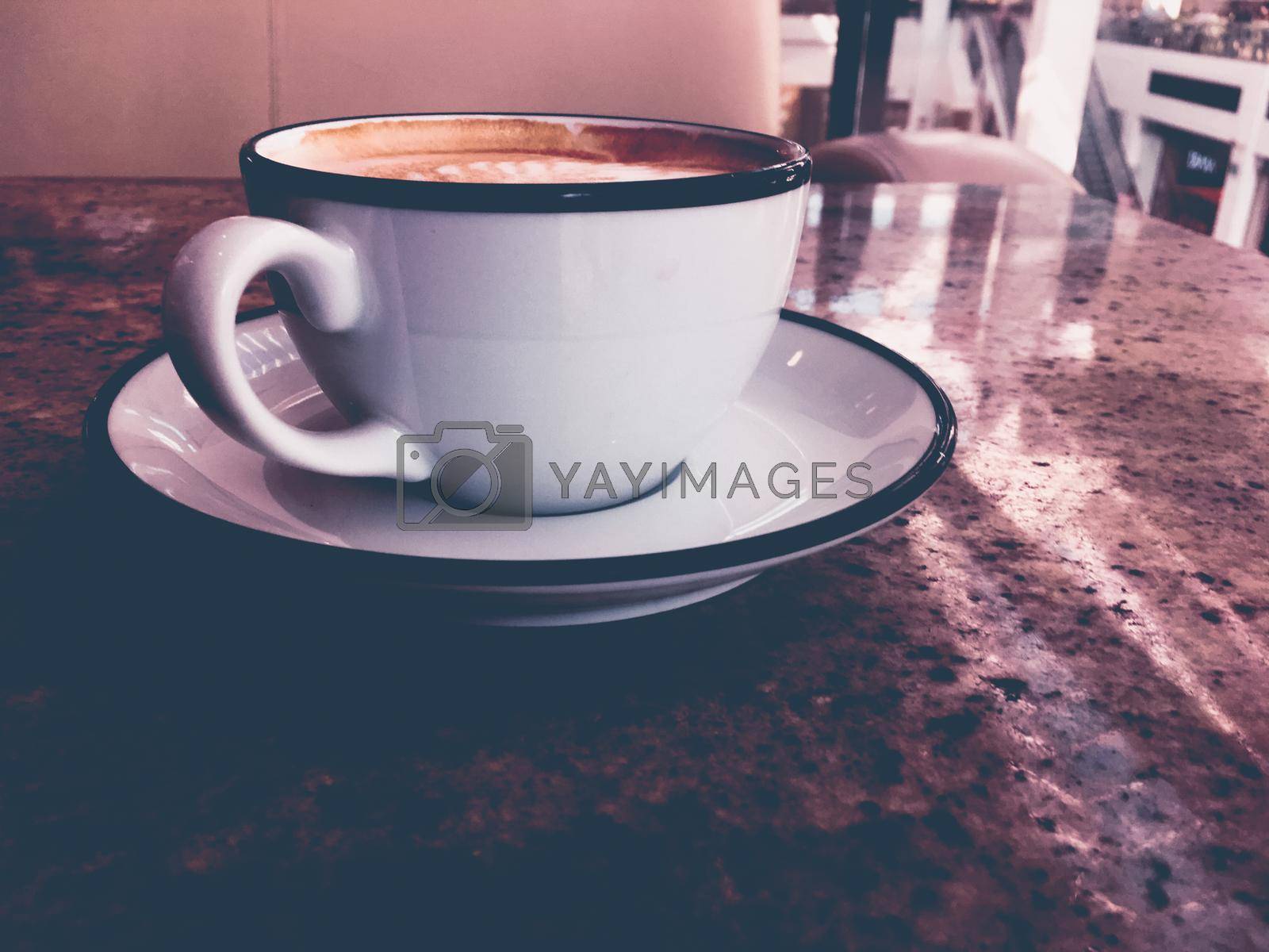 Royalty free image of Cappuccino for breakfast in cafeteria, coffee cup on table in parisian cafe by Anneleven