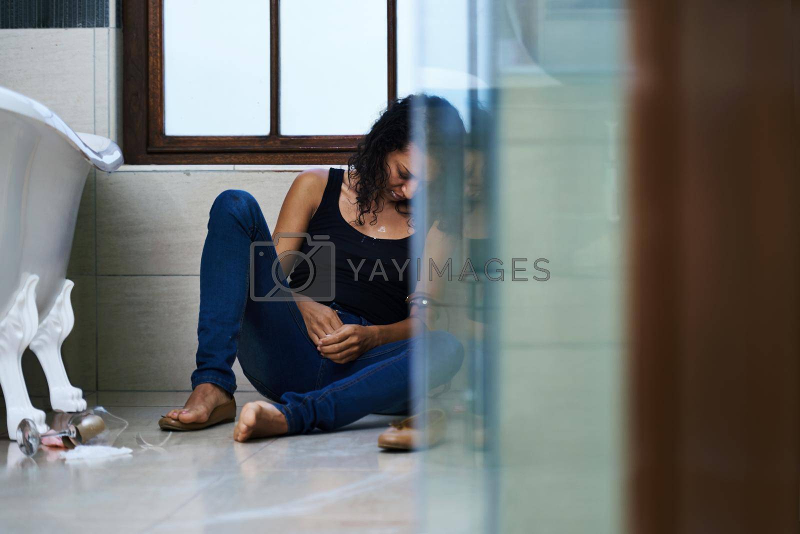 Royalty free image of Sick and tired. a drug addict passed out in the bathroom. by YuriArcurs