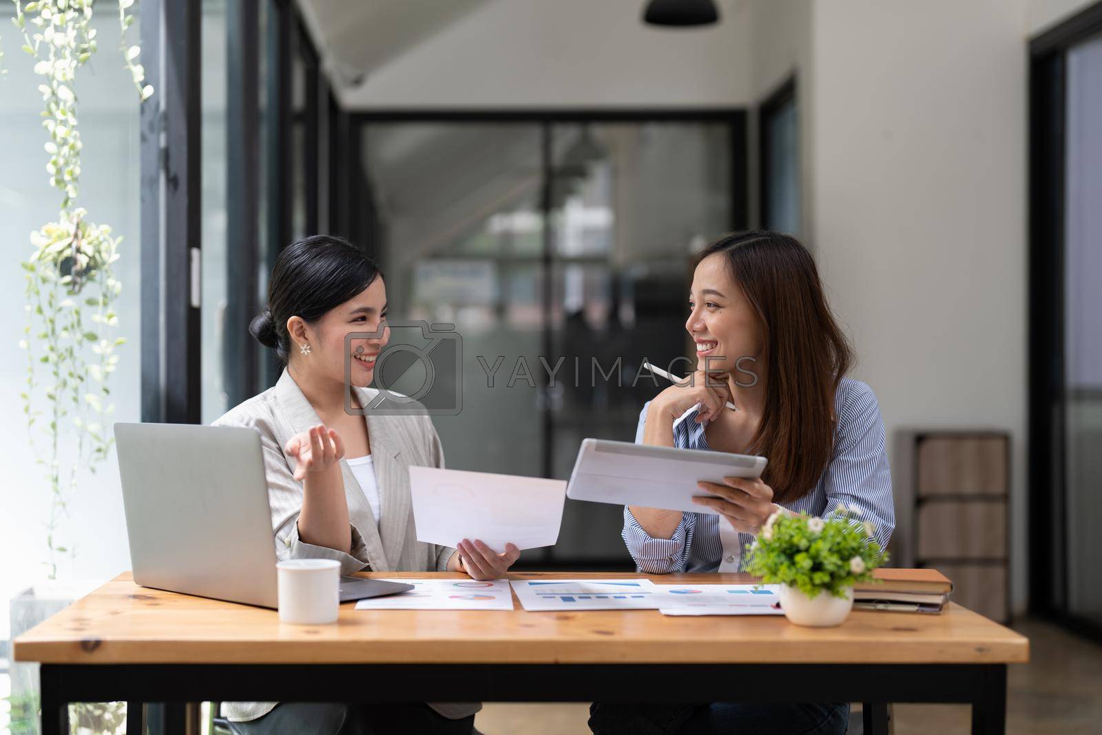 Royalty free image of Asian business adviser meeting to analyze and discuss the situation on the financial report in the meeting room.Investment Consultant, Financial advisor and accounting concept by nateemee