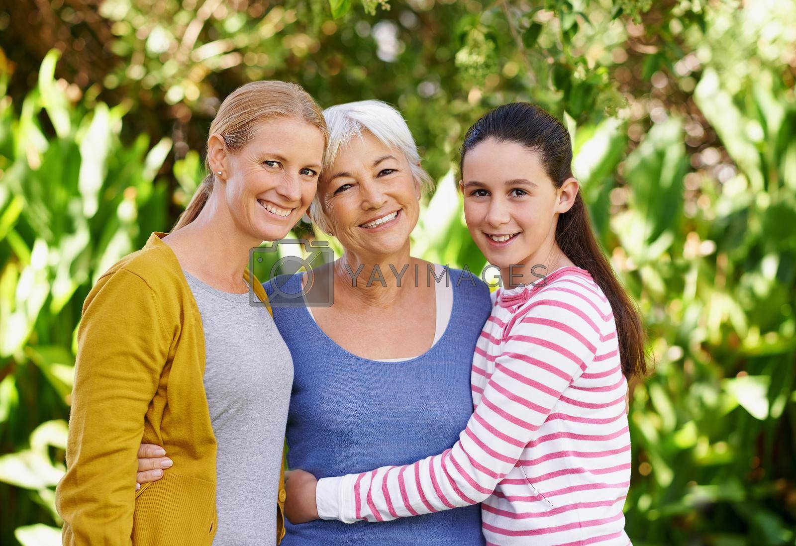Royalty free image of Blessed with both a daughter and a granddaughter. Portrait of a senior woman standing outdoors with her daughter and granddaughter. by YuriArcurs
