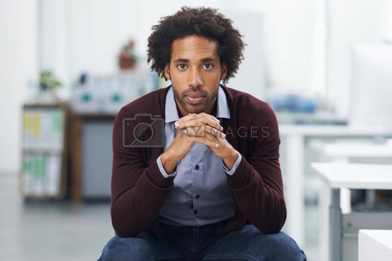 Hes serious about succeeding at work. a young businessman in an office leaning on his knees