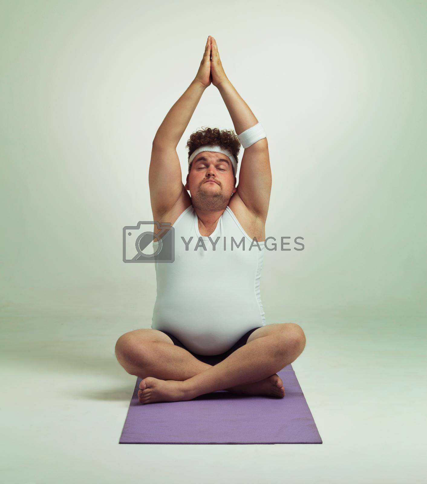 Being fit is easy especially with yoga. An overweight man doing a yoga pose