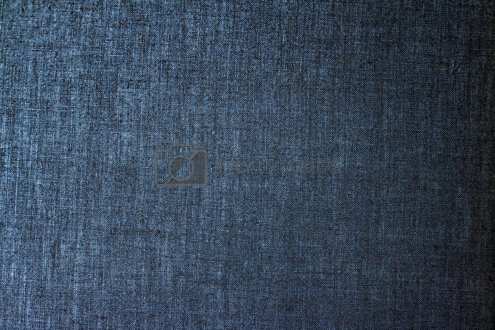 Royalty free image of Decorative linen blue jeans fabric textured background for interior, furniture design and fashion label backdrop by Anneleven