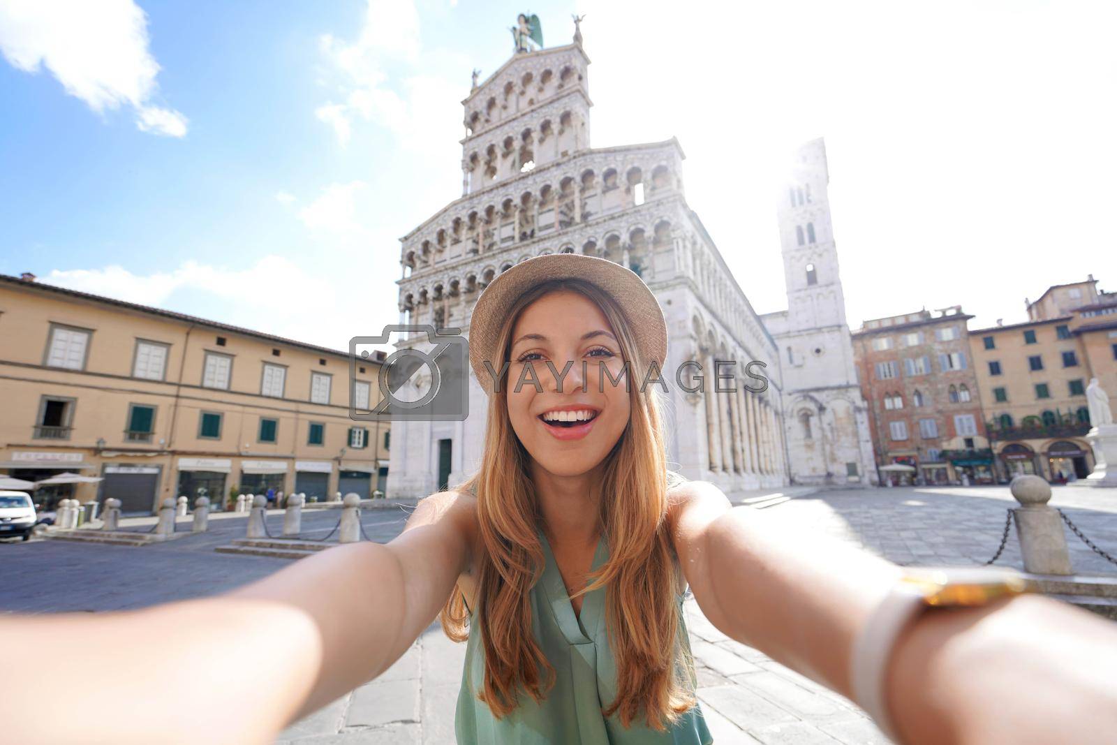 Royalty free image of Smiling traveler girl takes selfie photo in the historic town of Lucca, Tuscany, Italy by sergio_monti