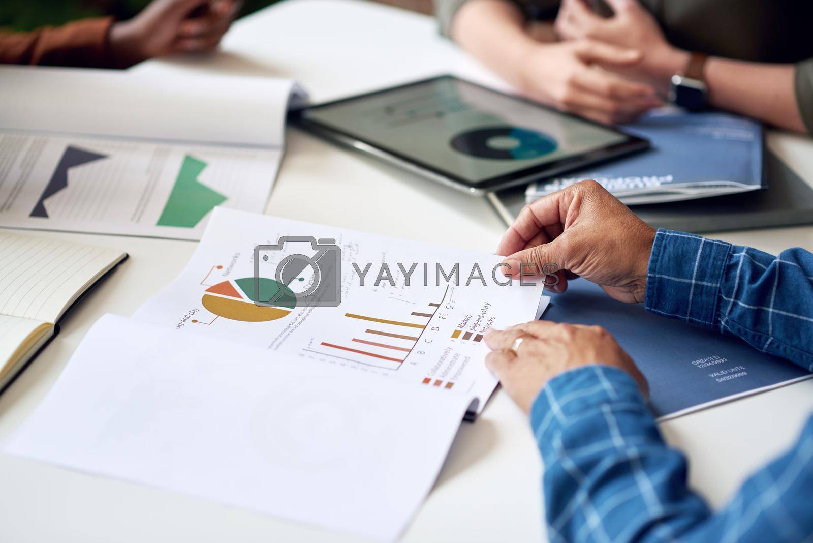 businessman hands holding financial document discussing data with colleagues in meeting brainstorming ideas using graph statistics.
