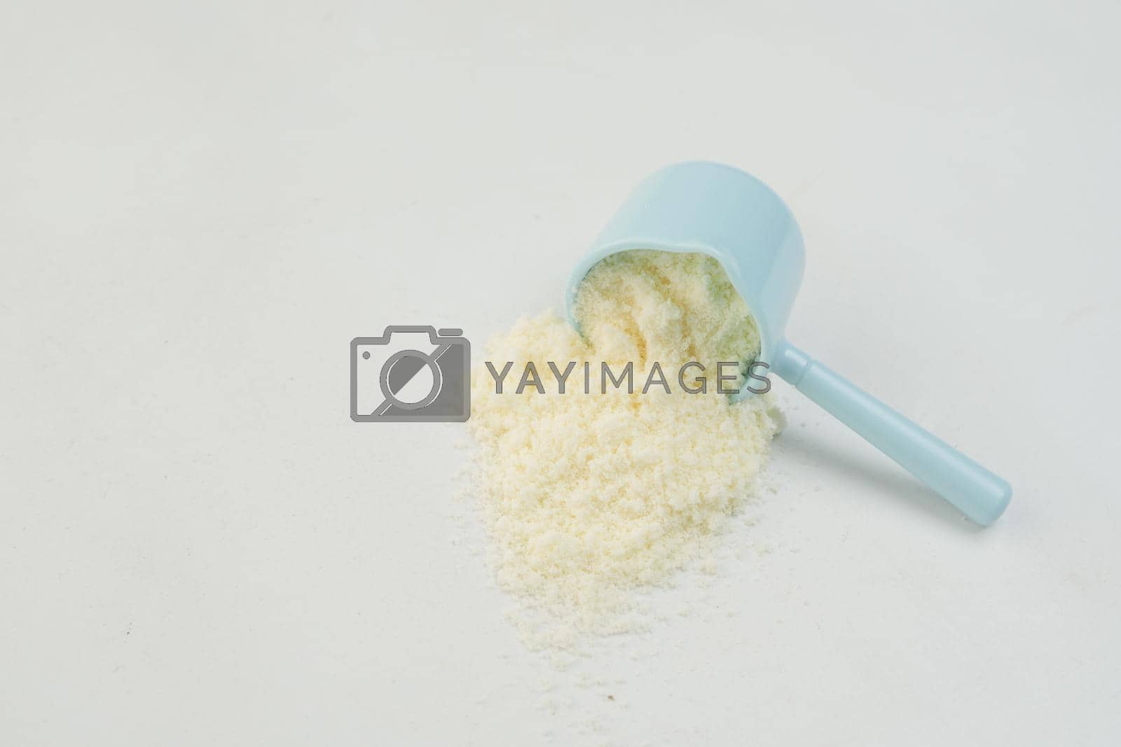 Royalty free image of Close up of baby milk powder and spoon on tile background. by towfiq007