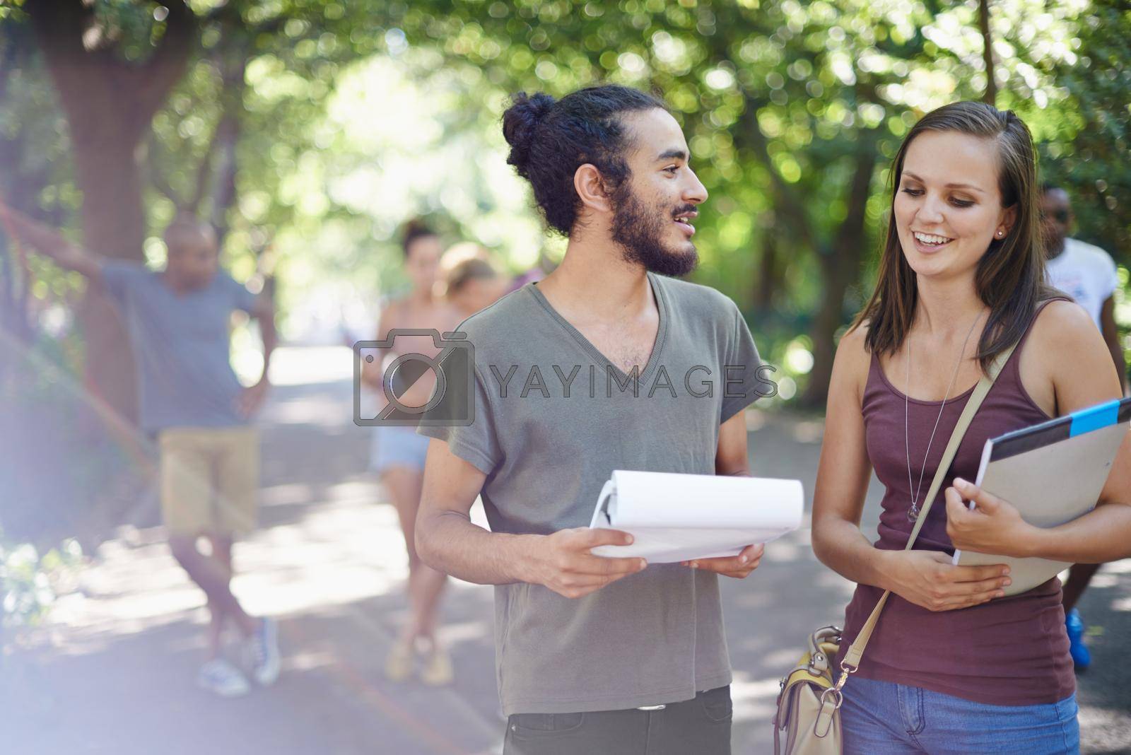 Royalty free image of Chatting in between classes. a male and female student chatting on campus. by YuriArcurs