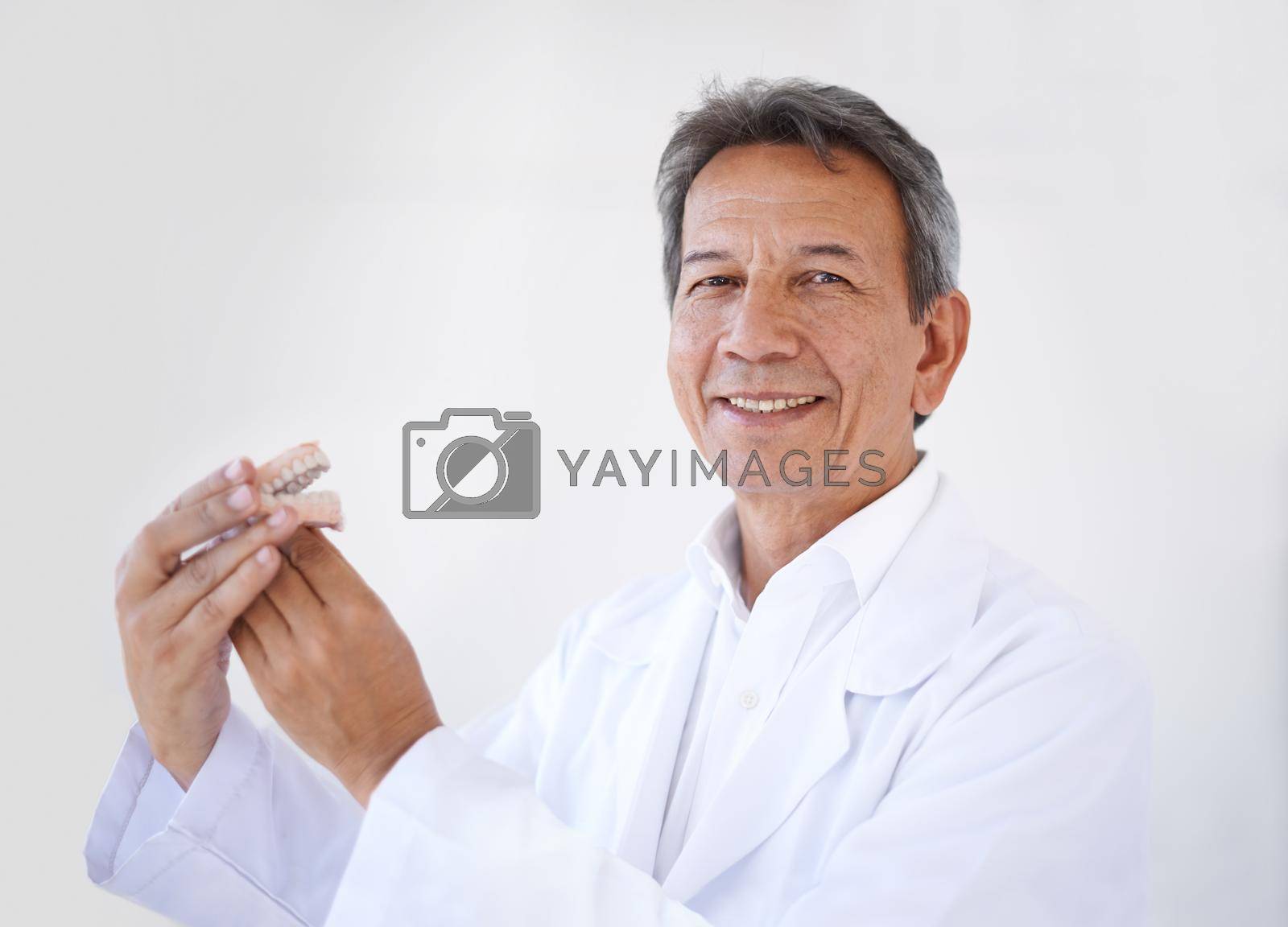 Hes the best surgeon around. Portrait of a mature male dental surgeon standing in his office