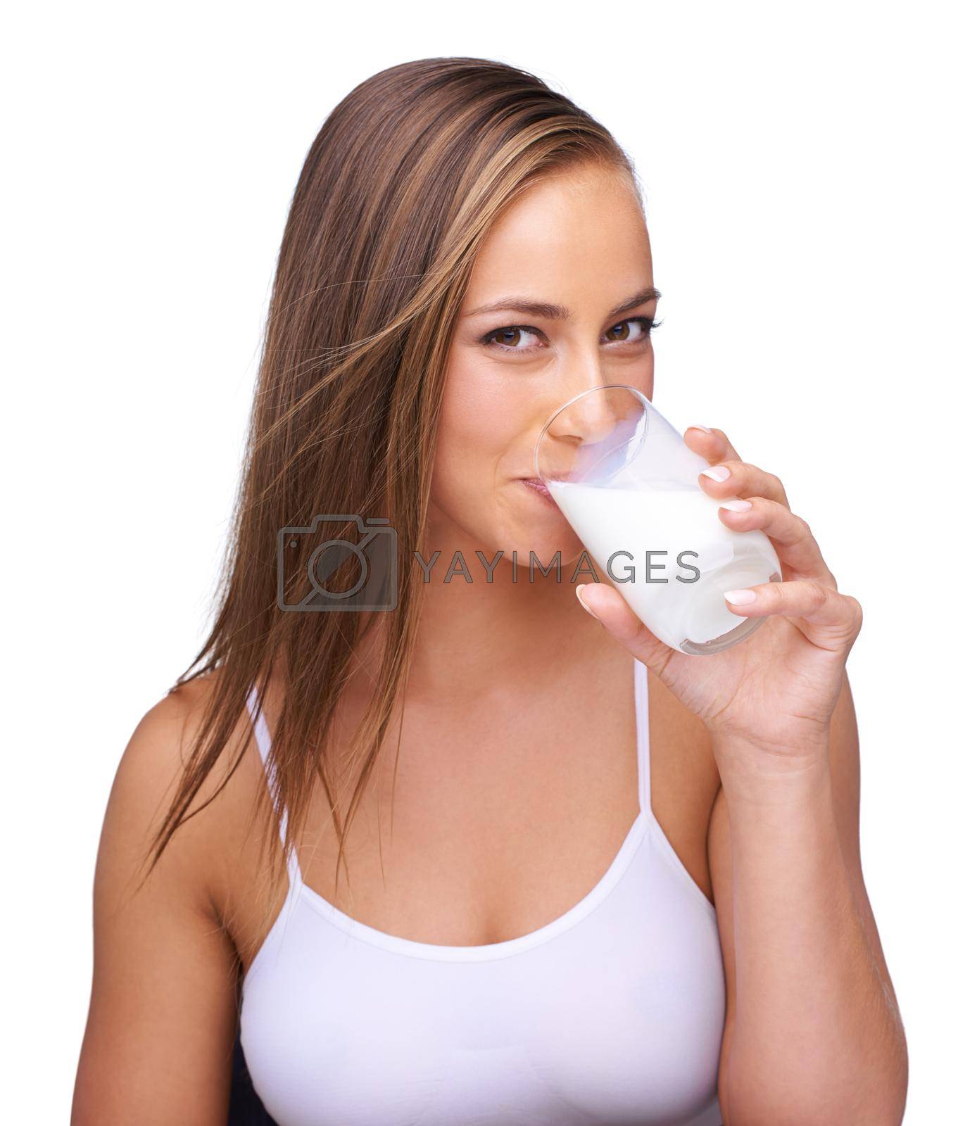 Royalty free image of It does the body good. a beautiful young woman drinking a glass of milk. by YuriArcurs