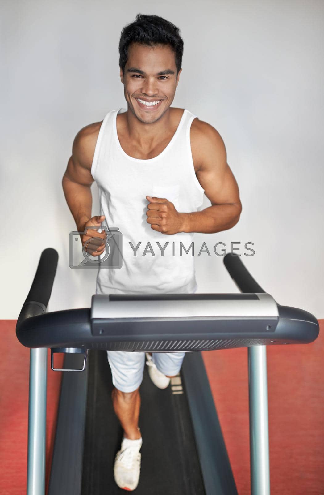 Royalty free image of Hes always in the gym. A young ethnic man exercising in the gym. by YuriArcurs