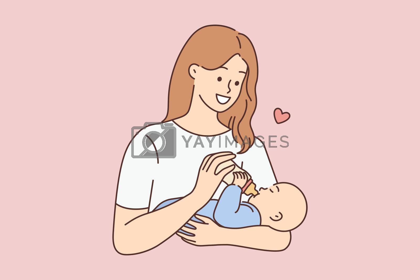 Royalty free image of Happy woman feeding infant by Vasilyeu