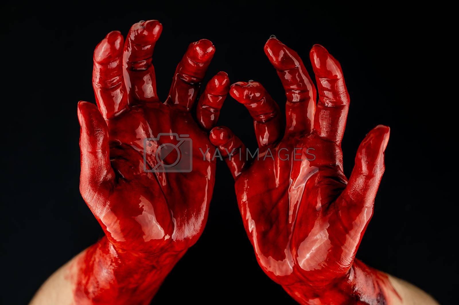 Royalty free image of Women's hands in blood on a black background. by mrwed54