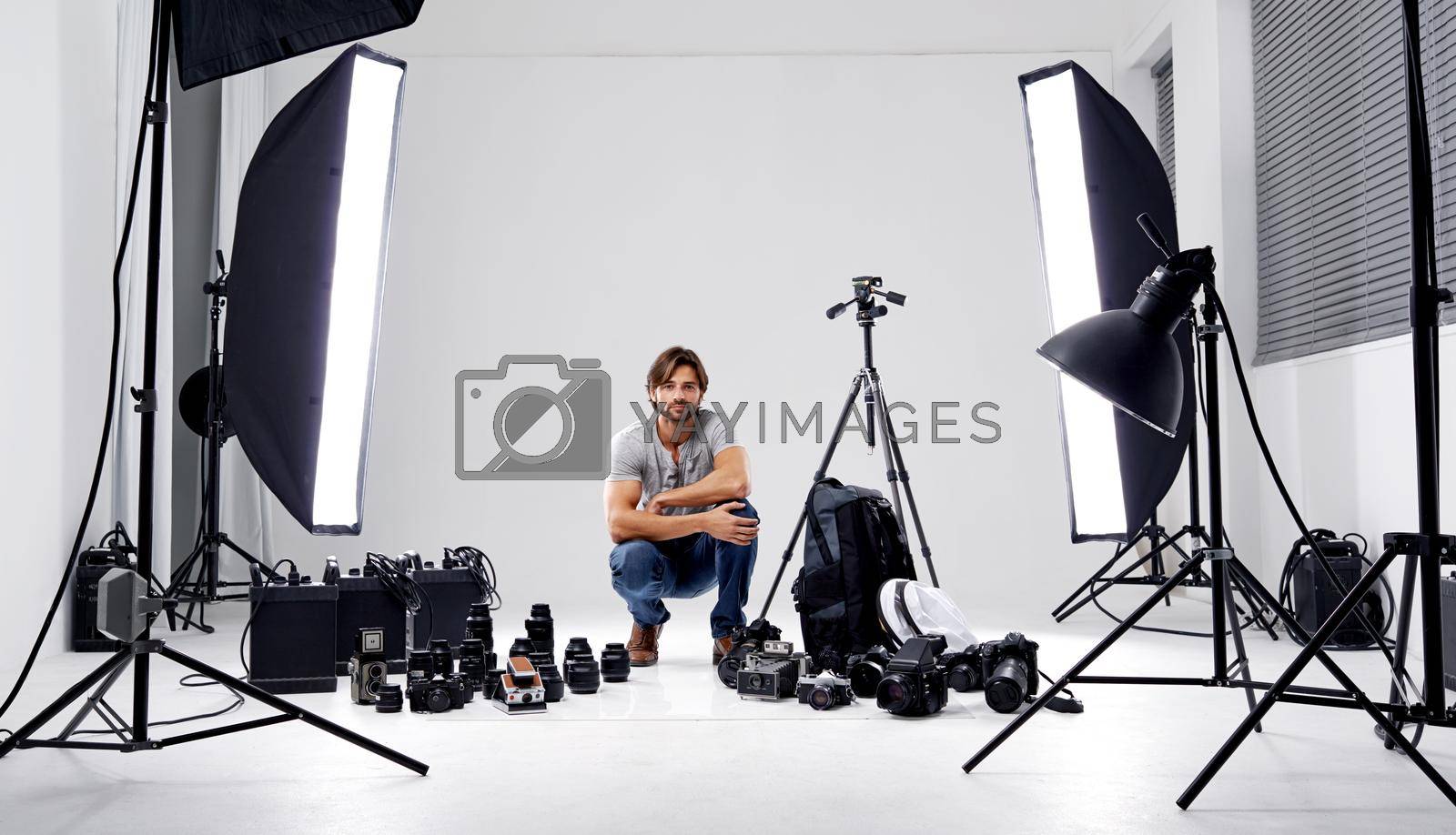 Royalty free image of Professional studio photography. A professional photographer in his studio surrounded by equipment. by YuriArcurs