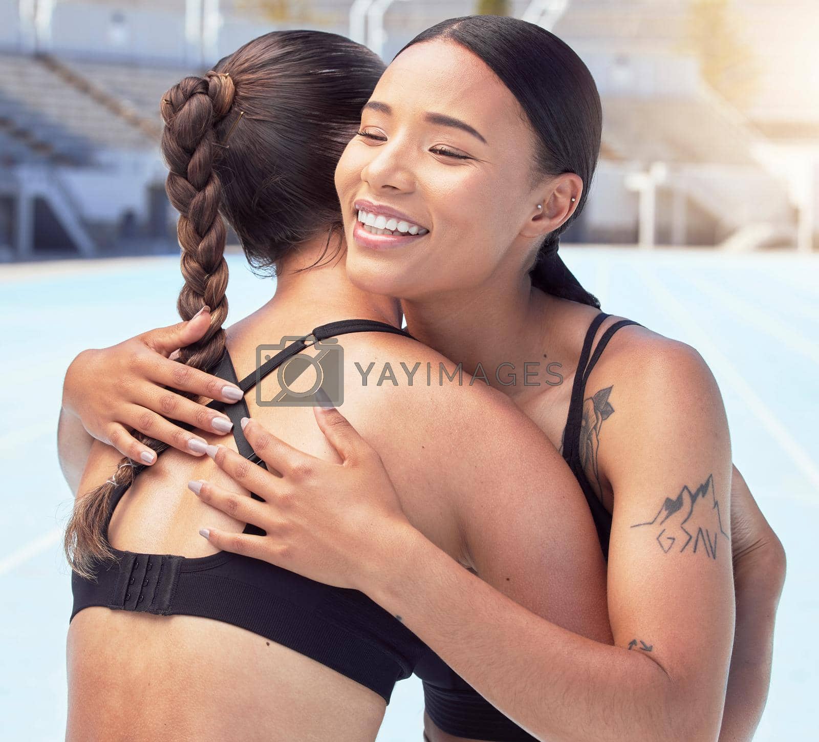 Royalty free image of Sports, fitness or athlete woman hug for support, love and motivation or congratulations winning at outdoor arena or stadium. Happy young diversity runner people embrace for healthy workout training by YuriArcurs
