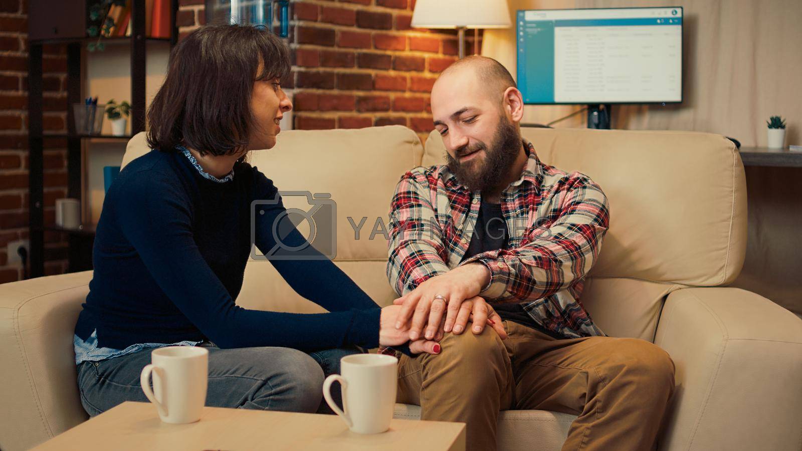 Royalty free image of Husband and wife solving marriage problems at therapy session meeting by DCStudio