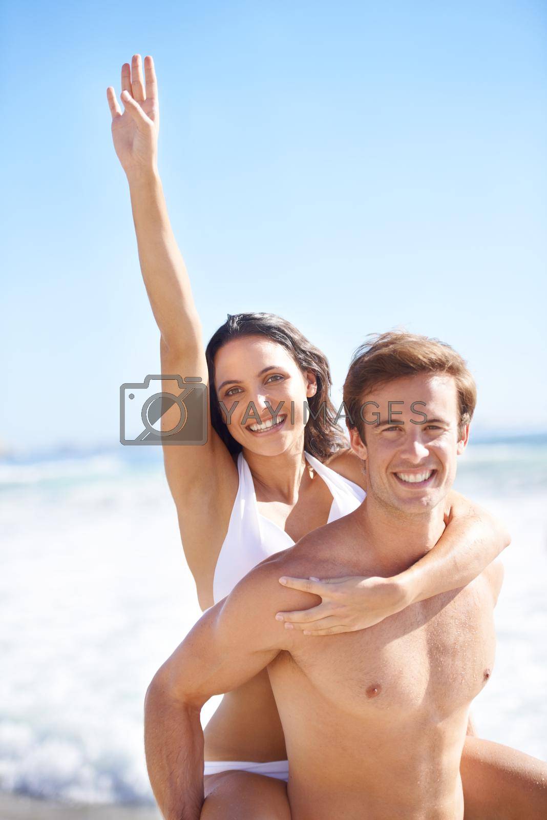 Romance and fun under the sun. A lovely young couple having fun on the beach in summer