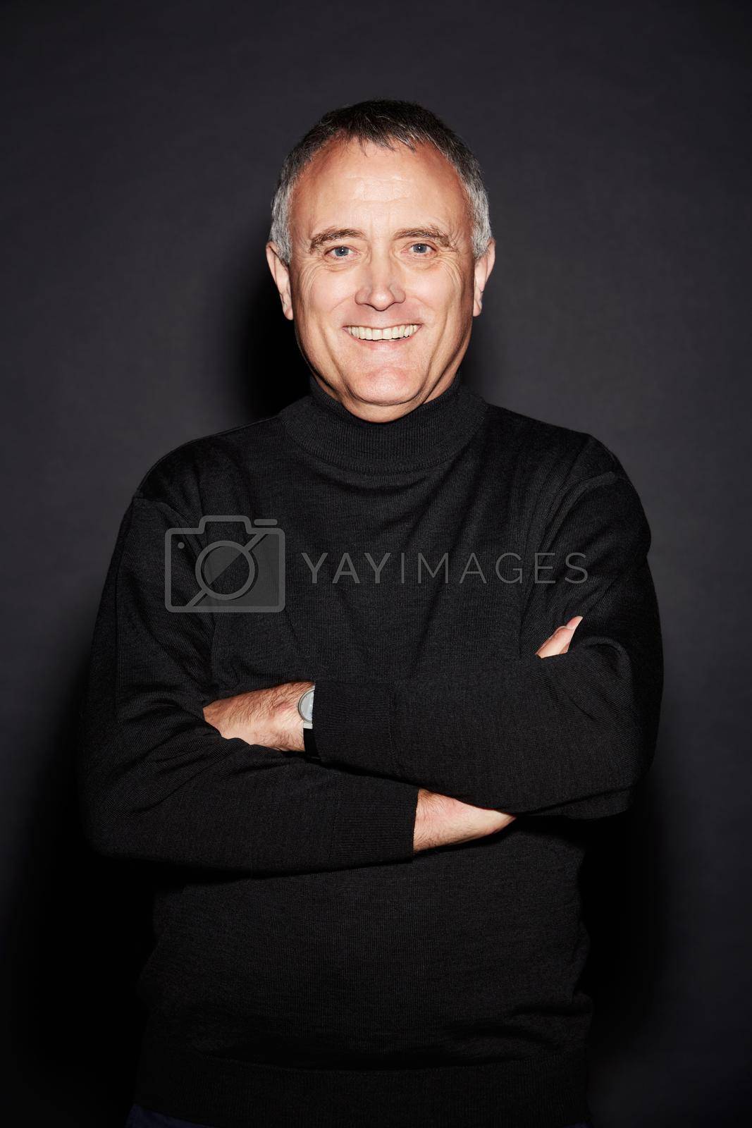 Royalty free image of Feeling positive about the future. Studio portrait of a mature man isolated on black. by YuriArcurs
