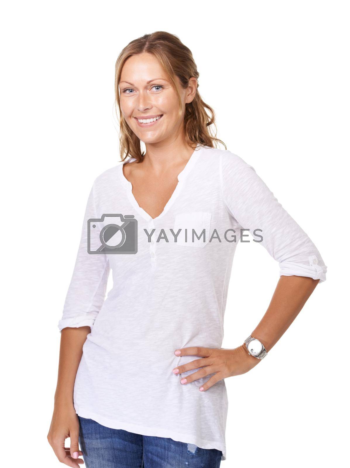 Royalty free image of She has a relaxed attitude toward life. A happy young woman standing with her hand on her hip against a white background. by YuriArcurs