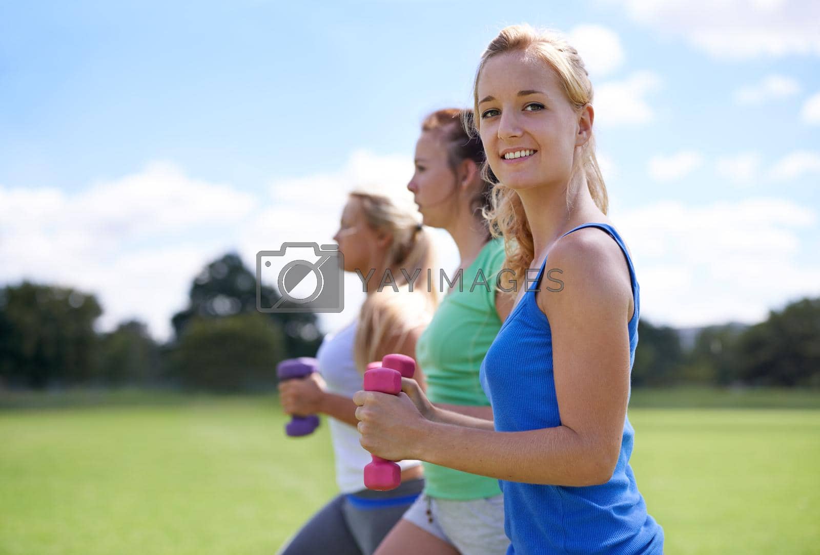 Royalty free image of Sunshine and exercise. a group of young women exercising outdoors. by YuriArcurs