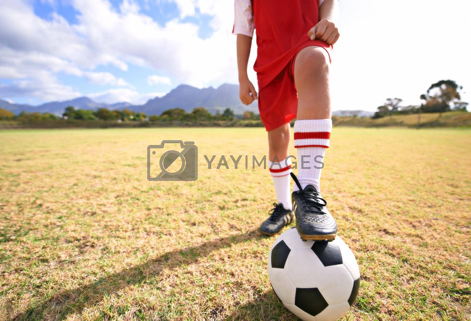 Royalty free image of Ready to kick-off. a young boys foot on a soccer ball. by YuriArcurs