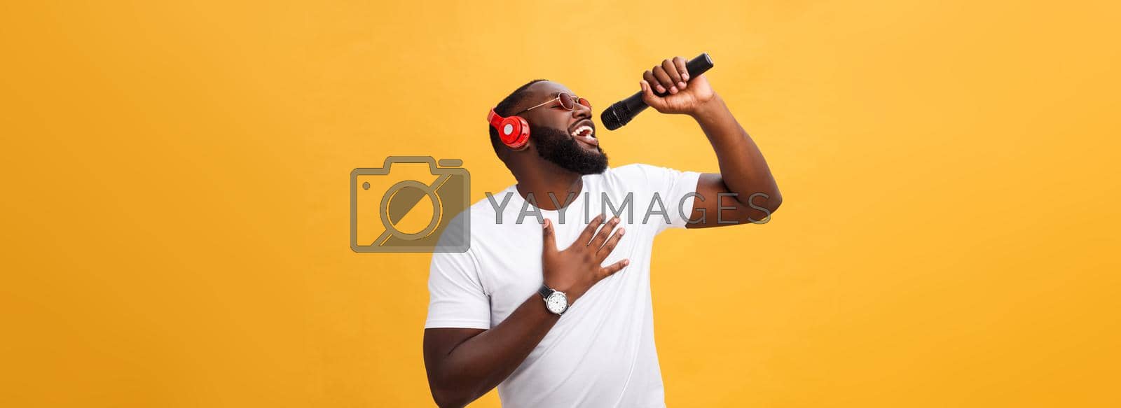 Royalty free image of young handsome african american boy singing emotional with micro by Benzoix