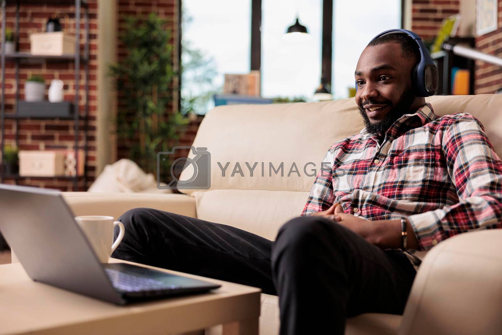 Royalty free image of African american freelancer listening to music by DCStudio