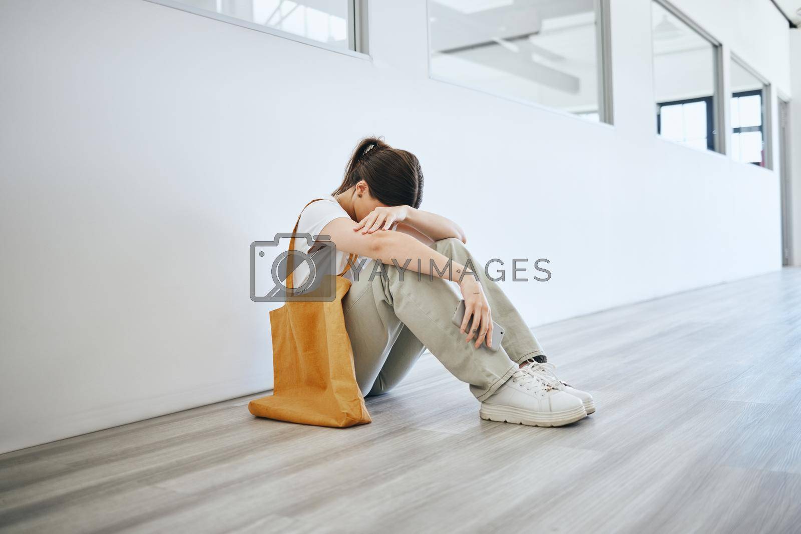 Royalty free image of Depression, stress and woman on the floor on an office, frustrated and suffering with mental health problem. Burnout, anxiety and pressure by jobless female feeling hopeless looking for a job by YuriArcurs