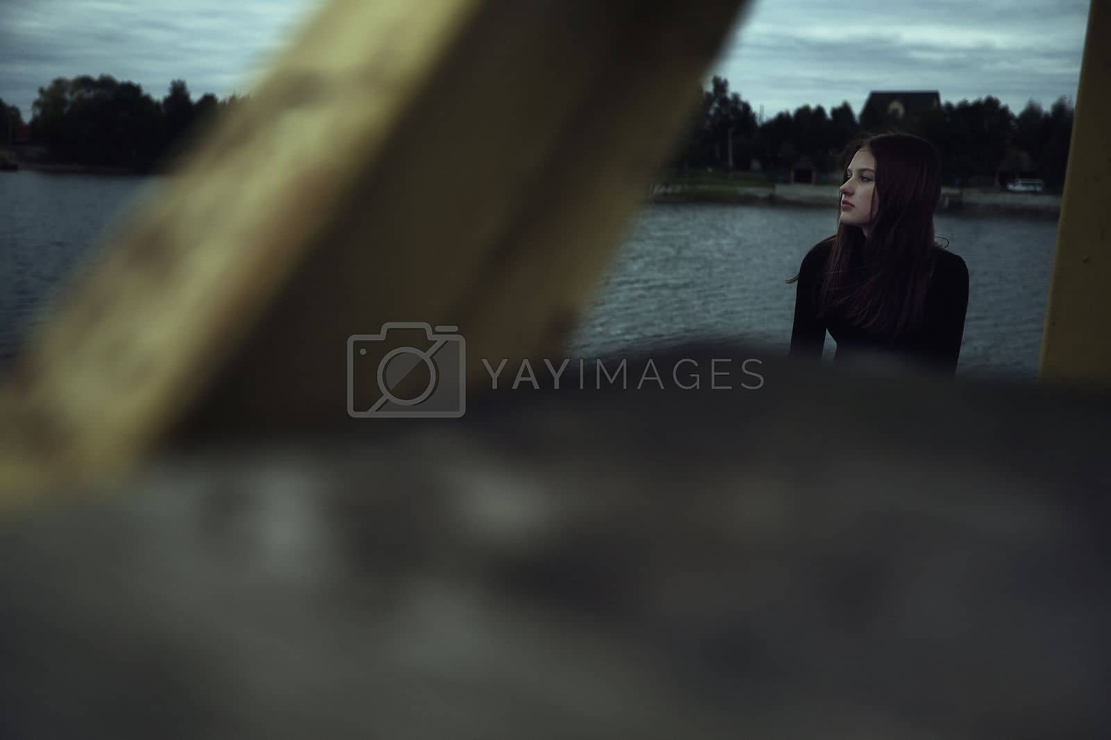 Royalty free image of girl bullying loneliness by the water lake teenager alone in solitude trying isolation cope with anger and find strength in the evening gloomy photo abandonment thinking about fate is not easy and hard mooring at the pier by marselin888