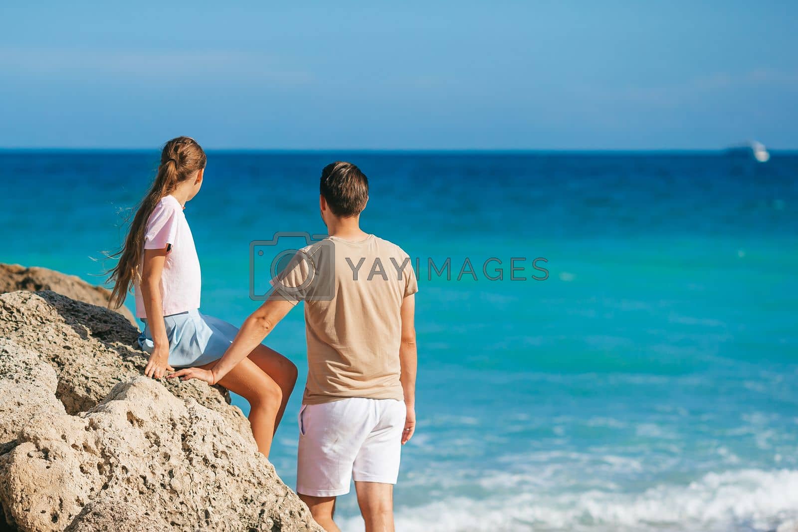Royalty free image of Family of dad and daughter together on the beach by travnikovstudio