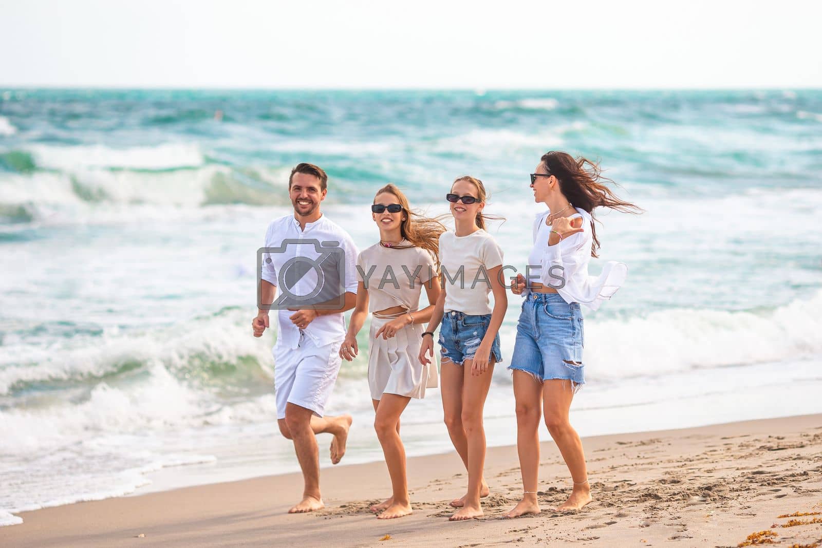 Royalty free image of Young family on vacation have a lot of fun by travnikovstudio