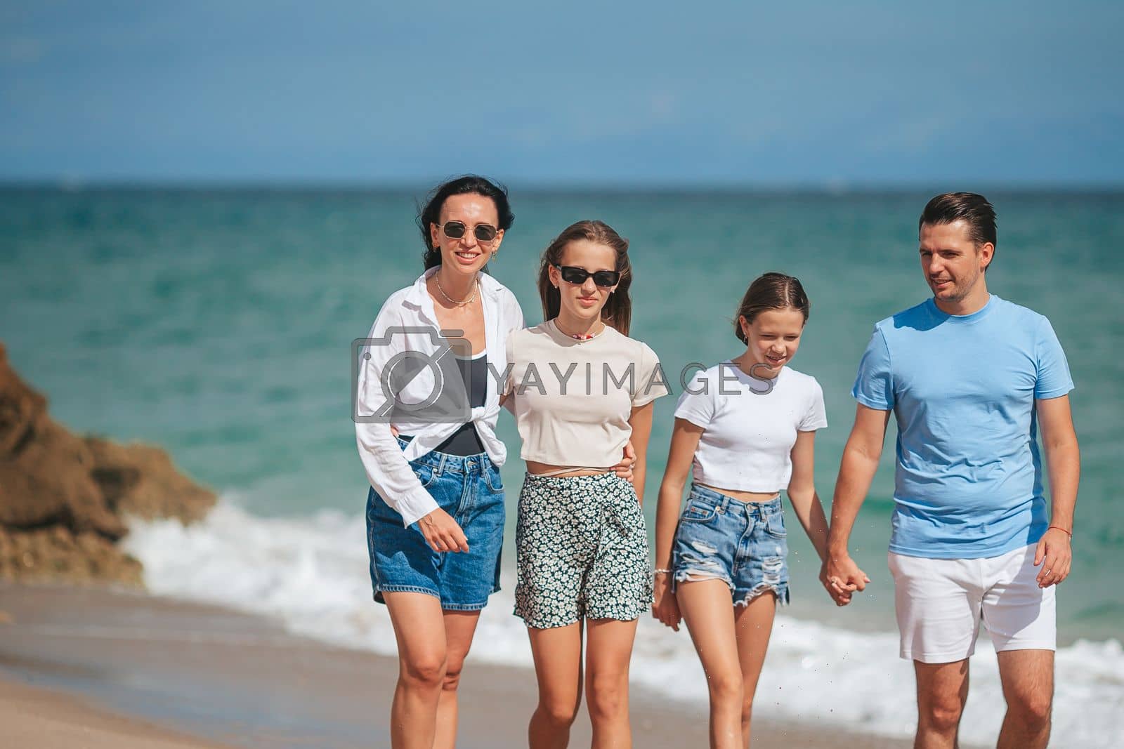 Royalty free image of Happy family on the beach during summer vacation by travnikovstudio