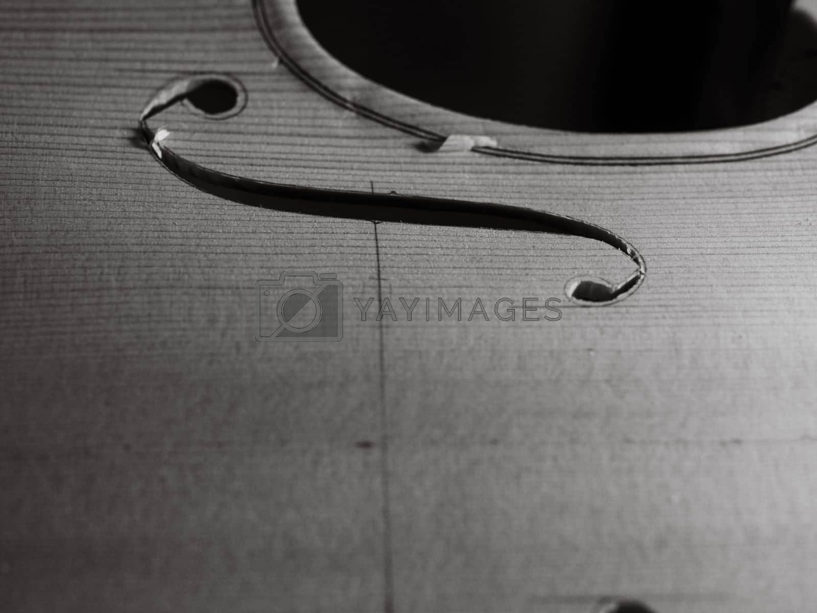 Royalty free image of luthier cutting and shaping violin f - hole by verbano