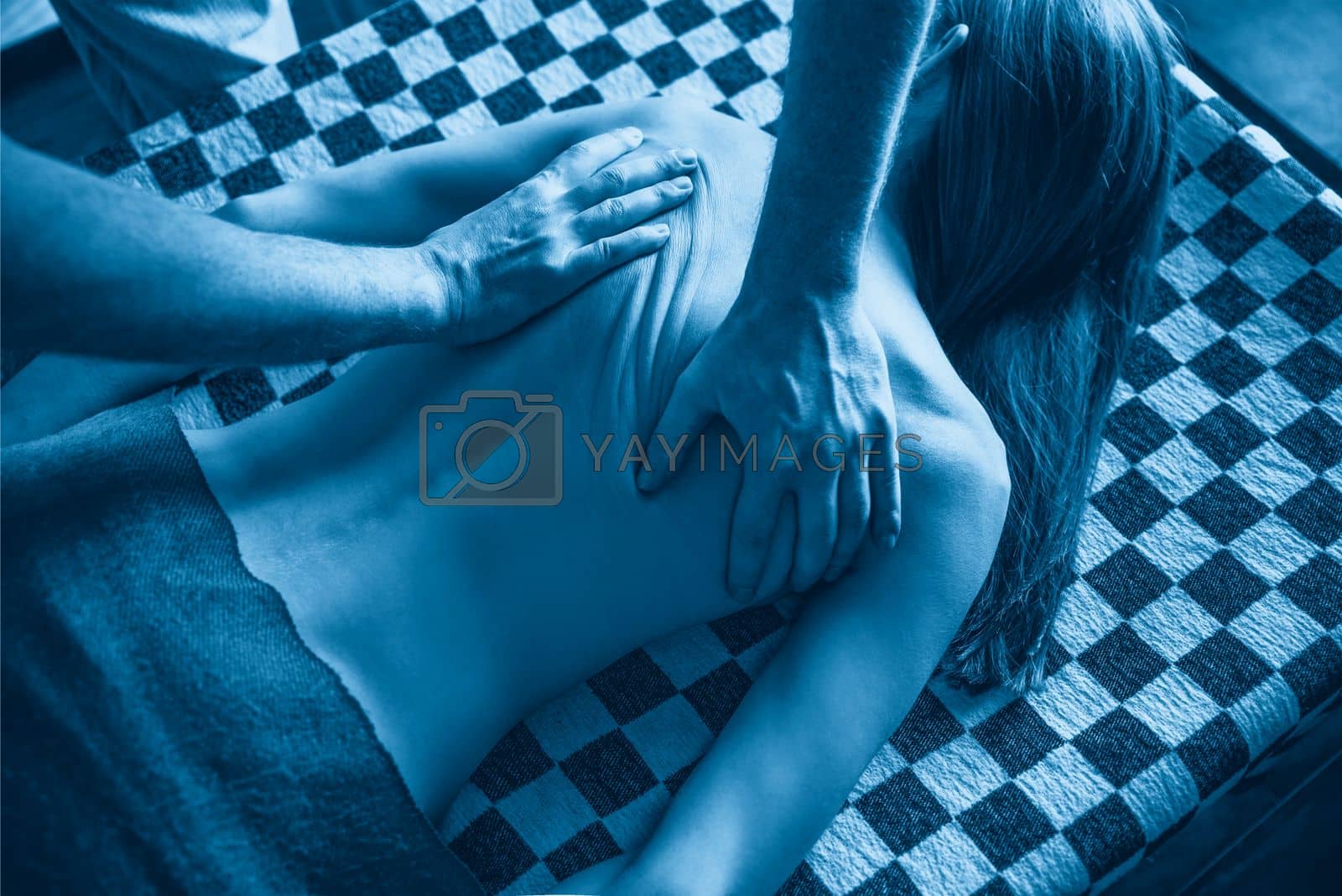 Royalty free image of Thai massage for woman with stretching and deep massage by Mariakray
