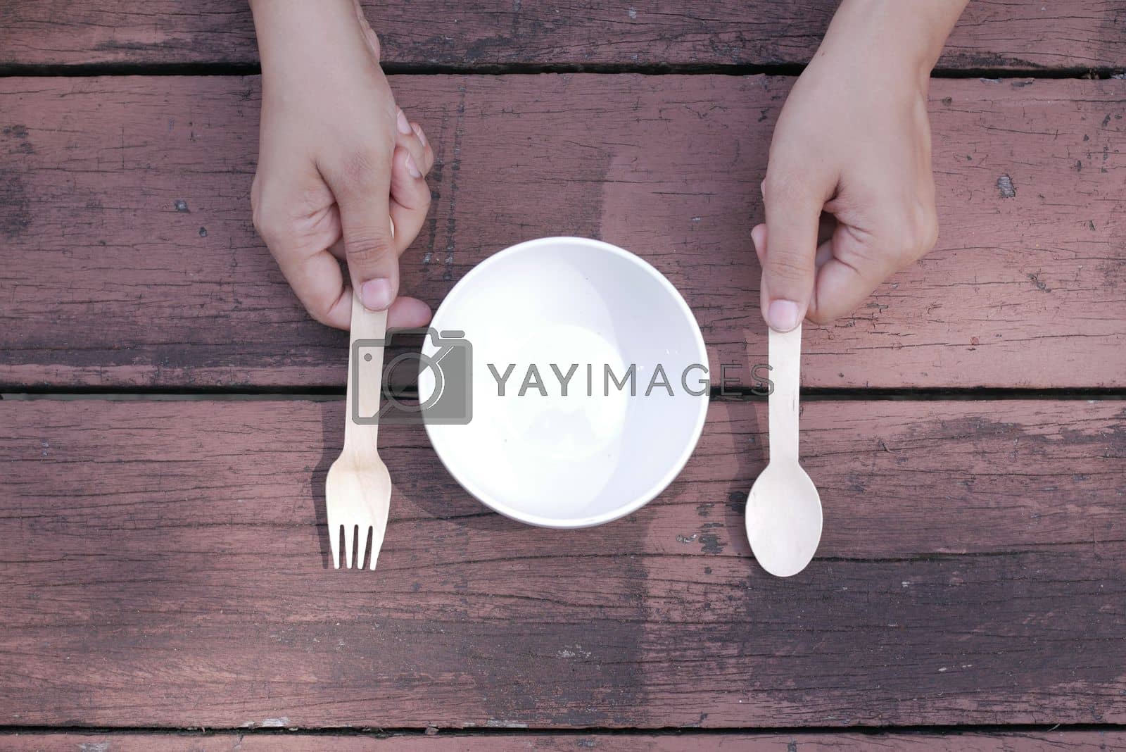 Royalty free image of cutlery and empty plate on wooden background top down by towfiq007
