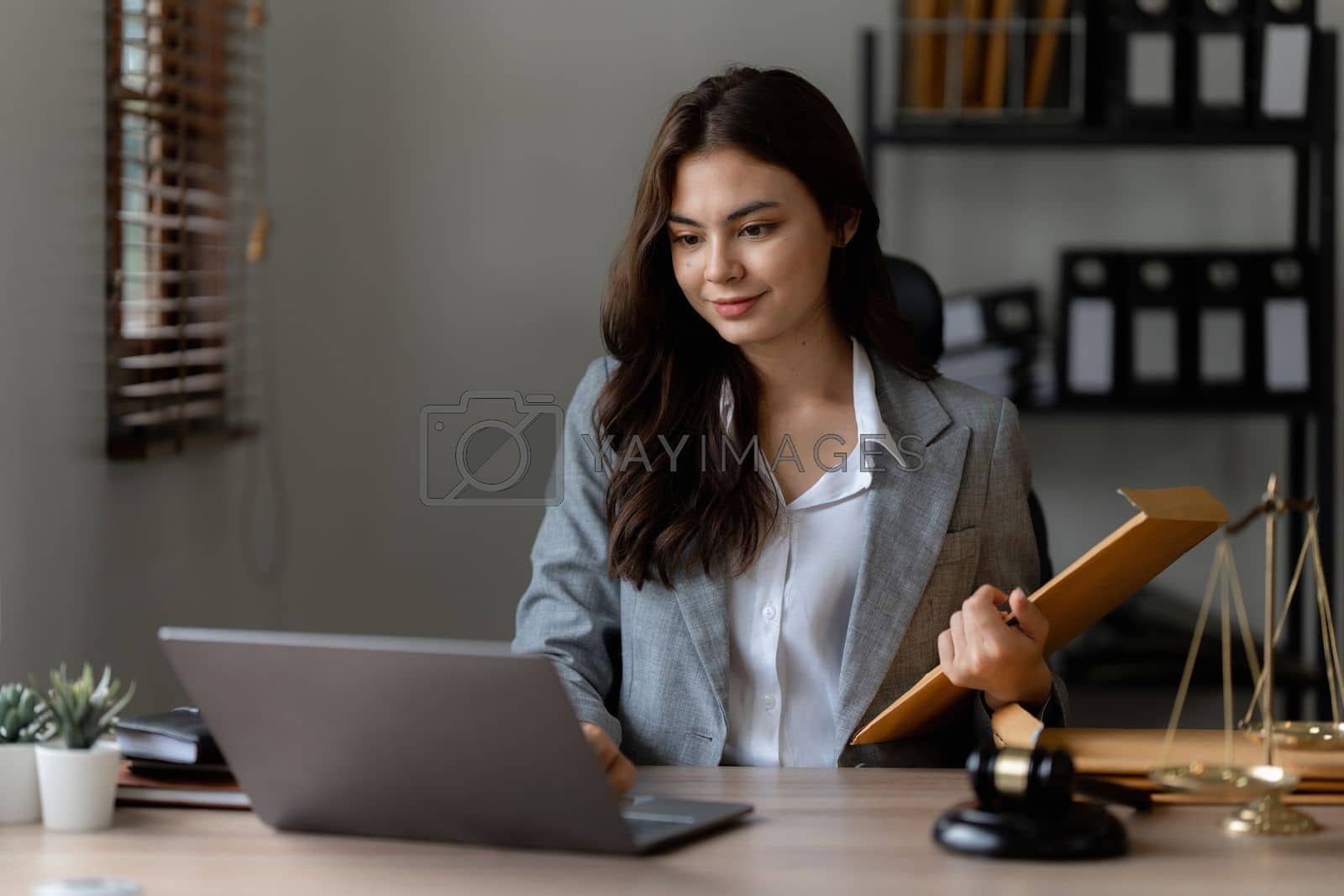 Royalty free image of Lawyer business woman working or reading agreement contract in office workplace for consultant lawyer concept by itchaznong