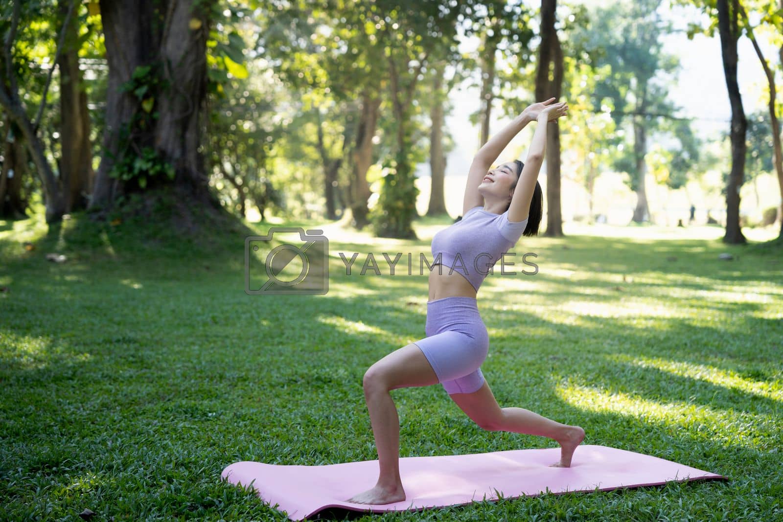 Royalty free image of Portrait of happiness young woman practicing yoga on outdoors.Yoga and relax concept. Beautiful girl practice asana by nateemee